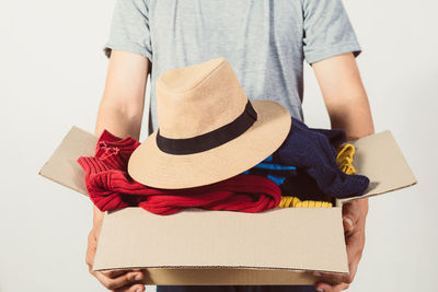 Rear view of woman wearing hat against white background