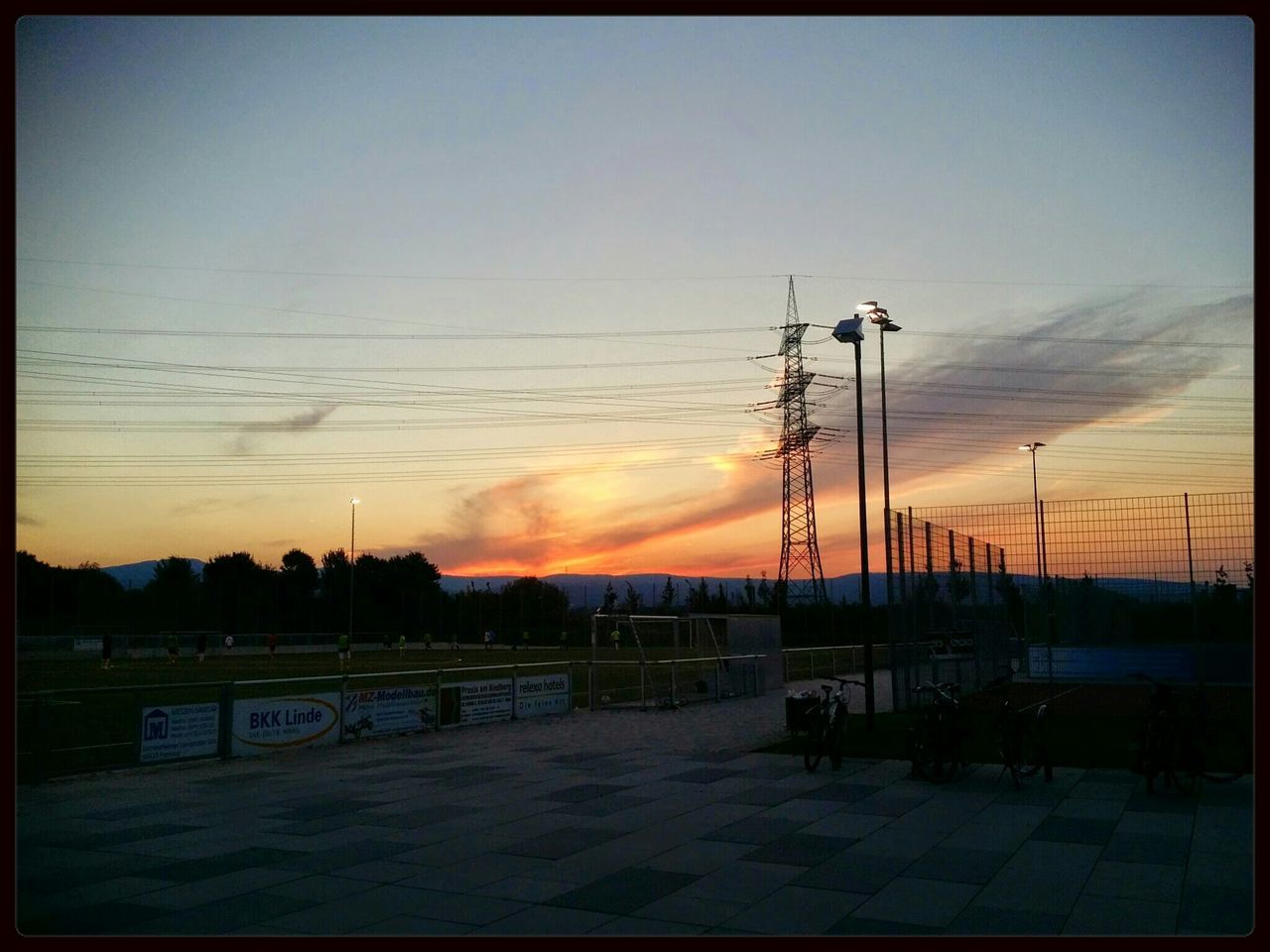 sunset, transfer print, sky, street light, silhouette, electricity pylon, power line, auto post production filter, electricity, orange color, tranquility, connection, nature, tranquil scene, scenics, outdoors, lighting equipment, built structure, beauty in nature, tree