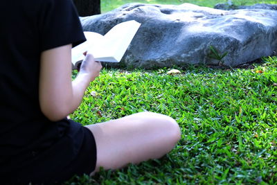 Close-up of hand on grass