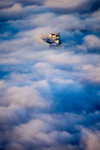 Fortress hohensalzburg rising above a sea of clouds, salzburg, austria