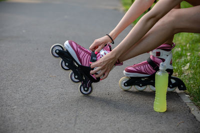 Low section of woman exercising on road