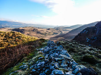 Scenic view of mountains against blue sky