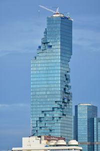 Modern skyscraper against blue sky