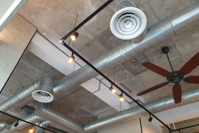 Low angle view of illuminated pendant lights hanging from ceiling