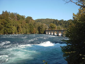 Bridge over river against clear sky