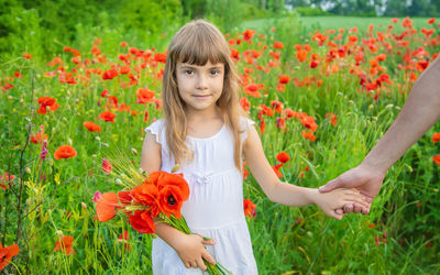 Portrait of young woman picking flowers