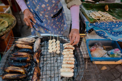 Man preparing food on barbecue grill