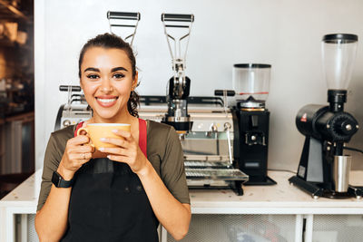 Portrait of a young woman drinking coffee