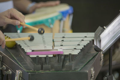 Cropped hands playing xylophone during event