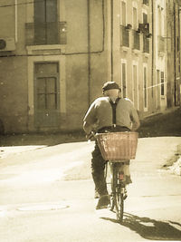 Rear view of a man walking on street