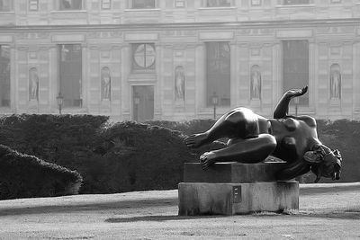 Statue against historic building