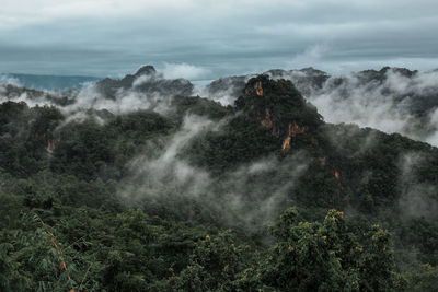 Scenic view of waterfall against sky