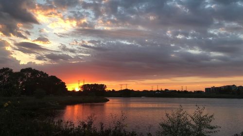 Scenic view of lake against orange sky