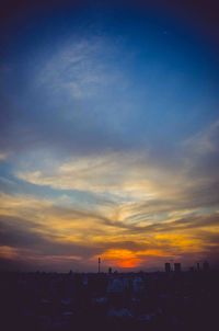Silhouette buildings against sky during sunset