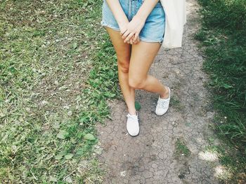 Low section of woman standing on ground