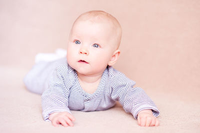 Cute baby boy against beige background