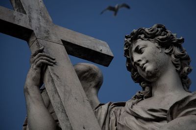 Low angle view of statue against sky