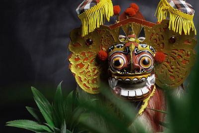 Colorful replica barong bali with a black background
