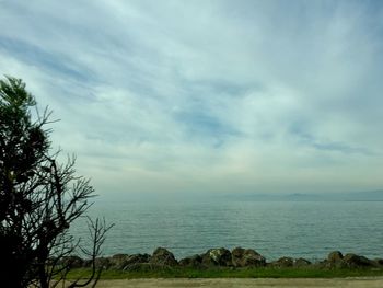 Scenic view of sea against cloudy sky