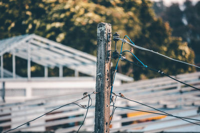 Close-up of barbed wire on metal fence