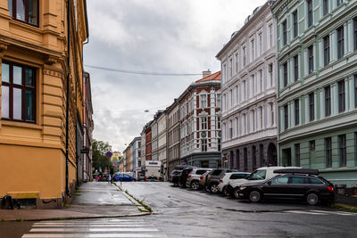 Cars on road amidst buildings in city