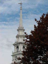 Low angle view of tower against cloudy sky