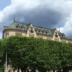 Low angle view of building against cloudy sky