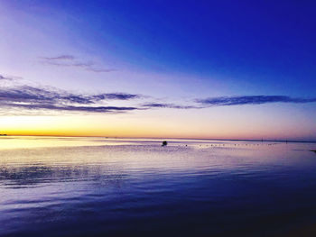 Scenic view of sea against sky at sunset