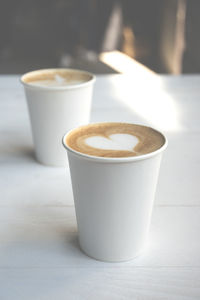 Close-up of coffee cups on table