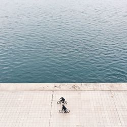 High angle view of bicycling against rippled water