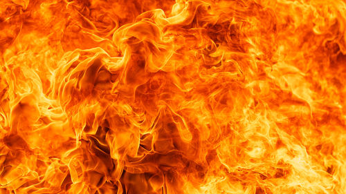 Close-up of fire burning against black background