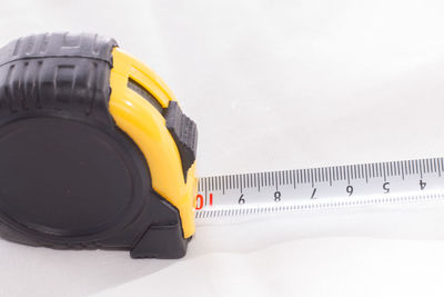 Close-up of yellow hat against white background