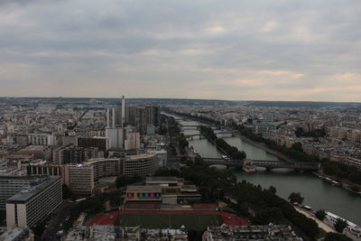 High angle view of buildings in city against cloudy sky