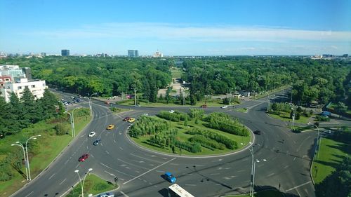 High angle view of cars on road in city against sky