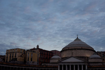 Low angle view of building against cloudy sky