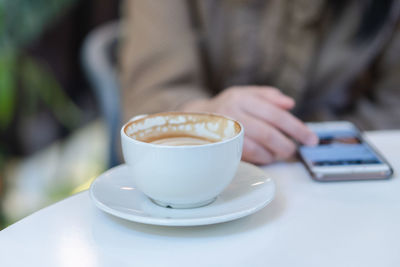 Close-up of coffee cup on table