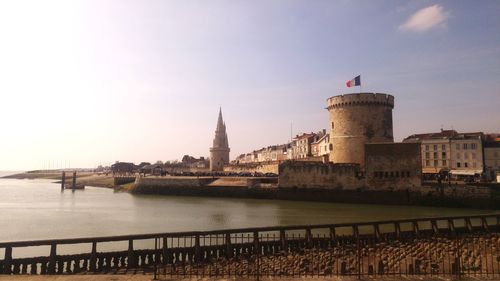 Bridge over river with buildings in background