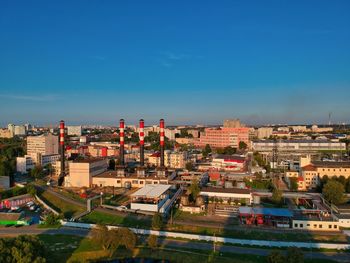 High angle view of buildings against blue sky