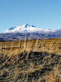 Scenic view of snowcapped mountains against clear sky