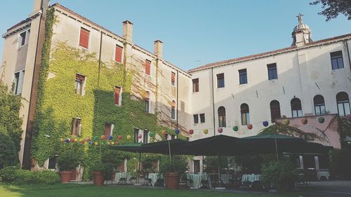 Low angle view of buildings against blue sky