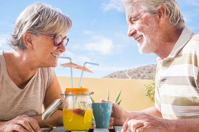 Close-up of senior couple having drink on table