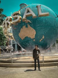 Digital composite image of man standing against sky in city