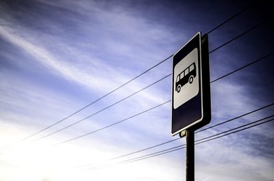 Low angle view of road sign against sky