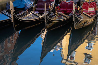 Low angle view of boats moored in canal