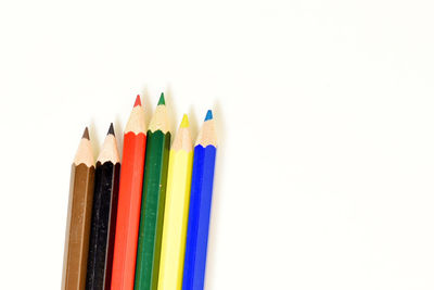 Close-up of colored pencils on white background