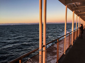 Pier on sea at sunset