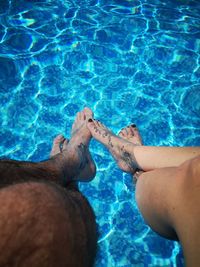 Low section of couple in swimming pool