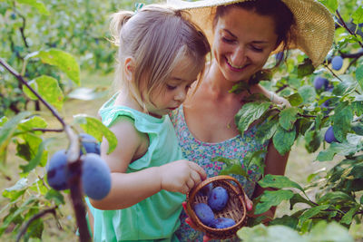 Side view of a smiling girl with plants