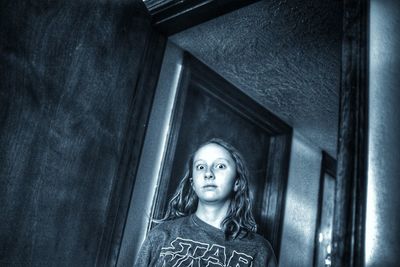 Portrait of woman standing against building