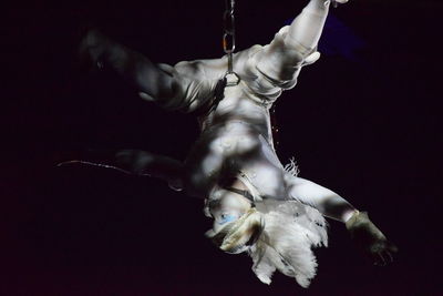 Close-up of illuminated lamp over black background